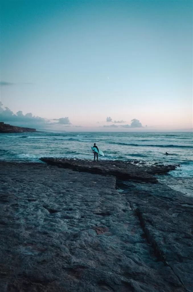 Surfer at Praia de Ribeira d'Ilhas, Ericeira, Portugal