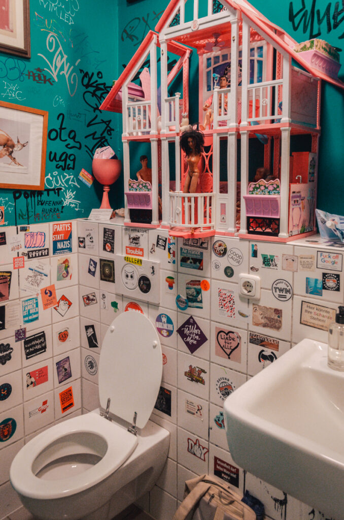 The funky toilet with a barbie house above the sink at vegan Café Nasch