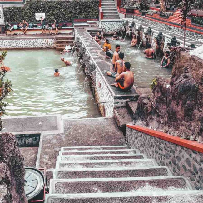 The main pool with local balinese people bathing of Banjar Hot Springs in Bali, Indonesia.