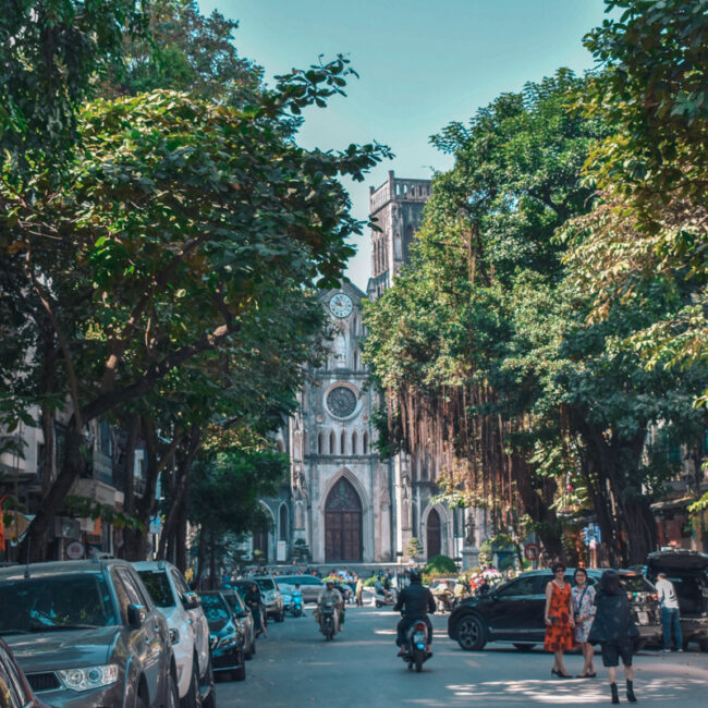 Streets of Hanoi, Vietnam. In this photo you can see motorbikes and a church.
