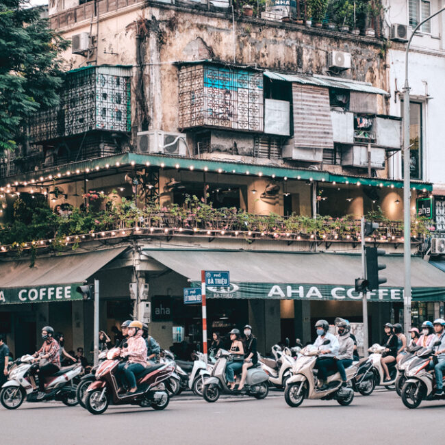 Streets of Hanoi, Vietnam. This is a crossroad with a coffee shops and dozens of motorbikes