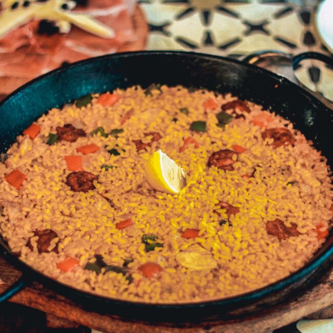 Vegan paella in Valencia, Spain. This a photo of a pan with vegan paella on a table.