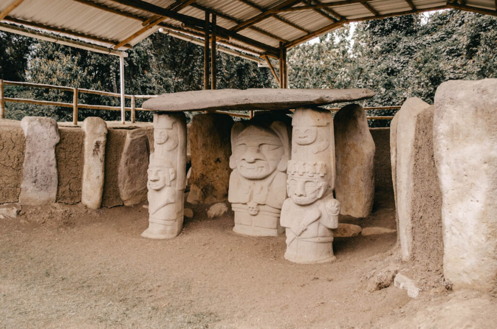 San Agustin Archeological Park, Buriel grounds, Colombia. You can see various statues that hold a rock together on their heads.