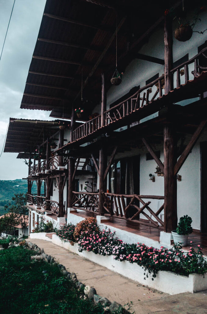 Antahkarana hotel, San Agustin, Colombia. this is a photo of the 8 rooms from the outside. It is comprised of wood and white walls.