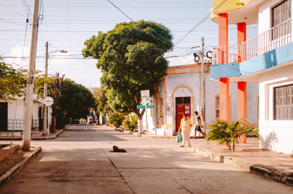 Dibulla town, Colombia. This is a photo of a street in Dibulla. A dog is lying in the middle of the street.
