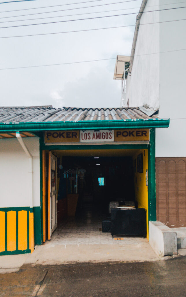 Entrance to 'Los Amigos' venue in Salento, Colombia, a local spot for playing the traditional game of Tejo, an evening activity option for visitors.
