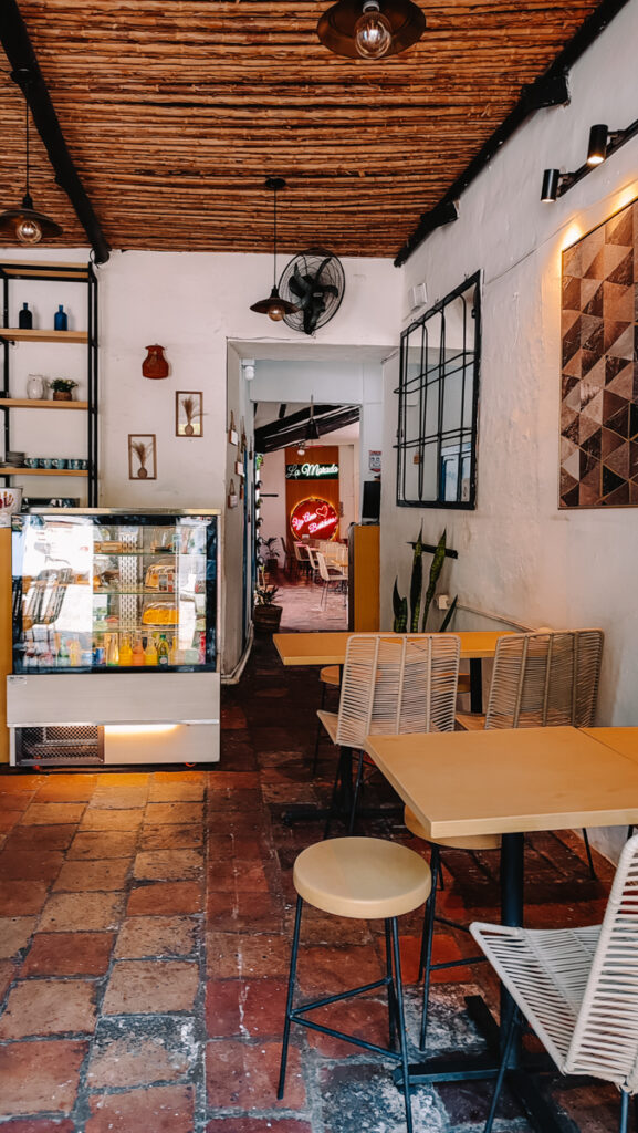 A restaurant with indoor seating arrangements in front of a wall in Barichara, Colombia.